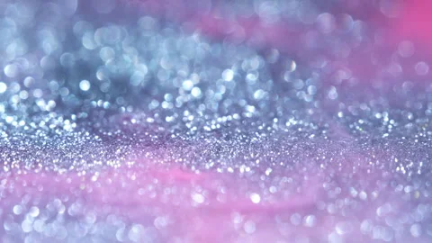 Macro bokeh of shimmering glitter particles in vibrant fluid motion Stock Footage 331747676