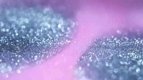 Macro bokeh of shimmering glitter particles in vibrant fluid motion Stock Footage 331747848