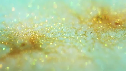 Macro bokeh of shimmering glitter particles in vibrant fluid motion Stock Footage 331750249