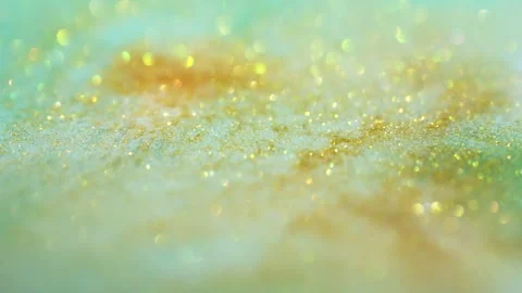 Macro bokeh of shimmering glitter particles in vibrant fluid motion Stock Footage 331751077