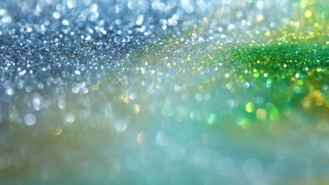 Macro bokeh of shimmering glitter particles in vibrant fluid motion Stock Footage 331751992