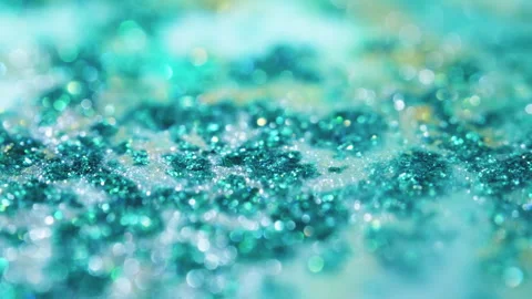 Macro bokeh of shimmering glitter particles in vibrant fluid motion Stock Footage 331754956
