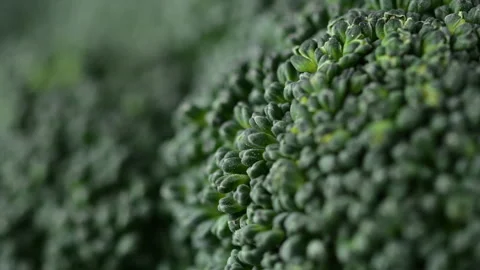 Macro broccoli head rotating over black background. Video stock 273795183