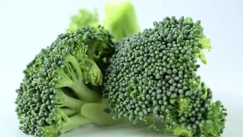 Macro broccoli slices rotating over white background. Stock Footage 273793989