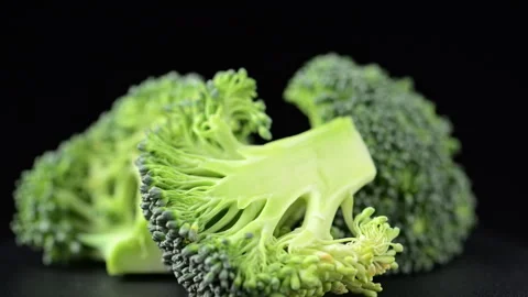 Macro broccoli slices rotating over black background. Video stock 276191230