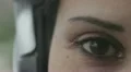 macro of a brown eye of woman with headphones HD Footage