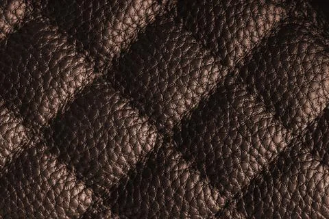 Macro of brown quilted leather texture background with stitched pattern and.. Stockfoto's