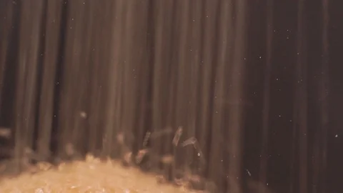 Macro, brown sugar falls into a transparent pot until it fills up Stock Footage 87265484