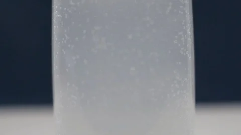 Macro Bubbles of Water Liquid Refreshing Chilled Drink in a Glass Stock Footage 129680555