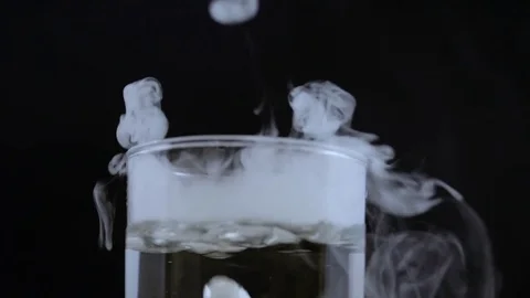 Macro bubbling smoking liquid with smoke rings Video stock 70705463