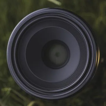 Macro camera lens in grass Stock Photos