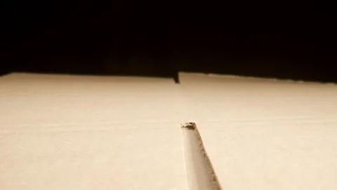 MACRO: Camera moves along a disassembled cardboard box Видео 181805253