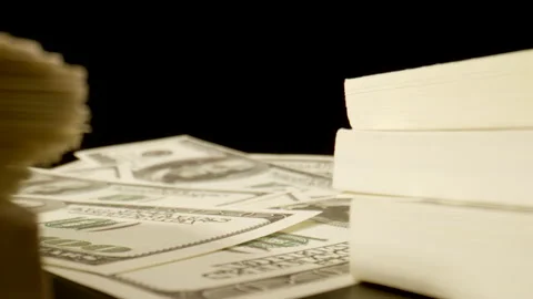 MACRO: Camera moves between stacks of US dollars on the table Видео 181796187