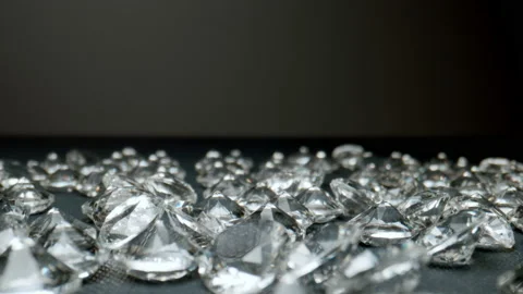 MACRO: Camera moves over a pile of diamonds on the table. Stock Footage 148193920