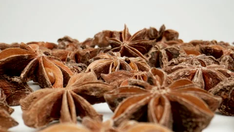 MACRO: Camera moving along scattered stars of star anise on a white background Видео 181783986