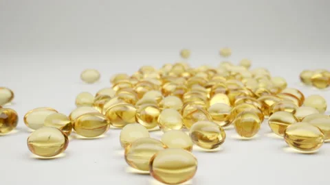 MACRO: Camera moving along  scattered capsules (drops) of vitamins Vídeo Stock 195769710