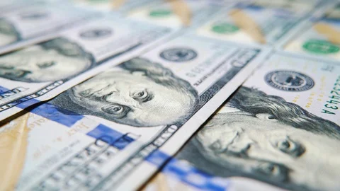 Macro camera sliding alongside US dollar bills lying in row Stock Footage 128874512