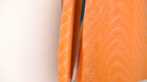 Macro Chef Cuts Salmon Fillet Slices For Cooking Sushi Closeup. Stock Footage 124741659