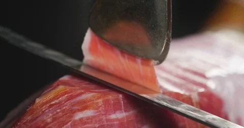 Macro of chef cuts slice of ham of excellent quality with knife Video stock 115393520