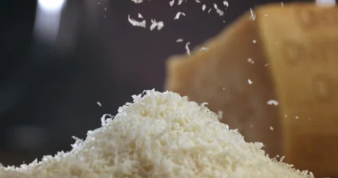Macro of chef grates parmesan cheese with steel grater on dish for prepare pasta Video stock 269326138
