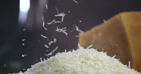 Macro of chef grates parmesan cheese with steel grater on dish for prepare pasta Video stock 269326846