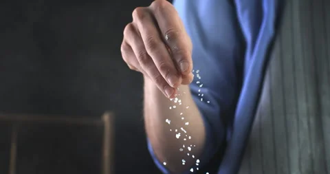 Macro of chef use salt on plate in kitchen Background at 1000fps. Video stock 269331181