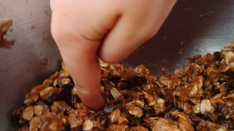 Macro child's finger scoops raw cookie dough as camera spins into place 스톡 동영상 129294134
