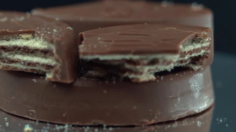 Macro chocolate candy, fluffy waffle, hazelnut crunch cookie on a rotating Stock Footage 304861270