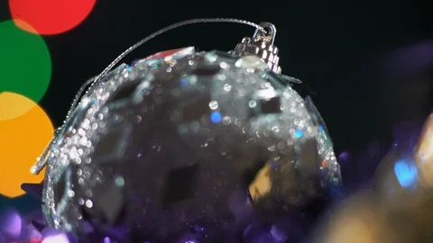 Macro, Christmas Tree Decorations Rotate on the Background of Glare Garlands Stock Footage 99154952