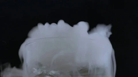 Macro clear beverage with lots of smoke and bubbling Stock-Footage 70705695