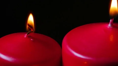 Macro close up up 3 lit red candles rotating around black background Stock Footage 70244268