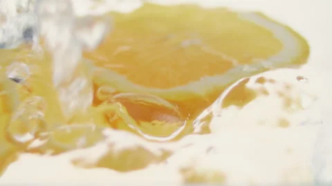 Macro close up of 3 slices of Orange  splashing in water in slow motion Stock Footage 273121822