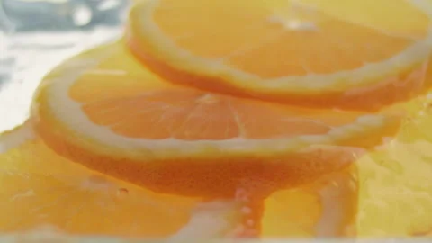Macro close up of 3 slices of Orange  splashing in water in slow motion Video stock 273121826