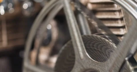 Macro close up of 8mm film strip tape spooling on to a reel from an old Vídeo Stock 249162450