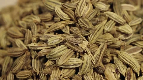 Macro close up of aniseed falling into a white bowl Stock Footage 156454554