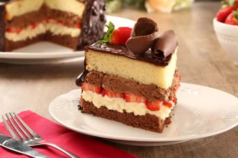 Macro close up of appetizing slice of dark chocolate cake and strawberry with Fotos Stock