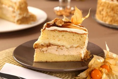 Macro close up of appetizing slice of white chocolate cake with nut and Physa Stock Photos