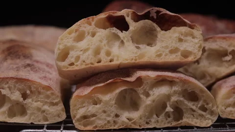 Macro close-up of artisan bread loaf showing crust and crumb texture Stock Footage 331207963