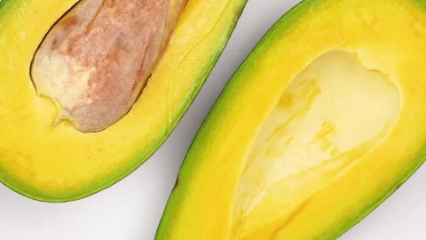 Macro Close Up Avocado Halves With Seed Rotating 4K Stock Footage 322084002