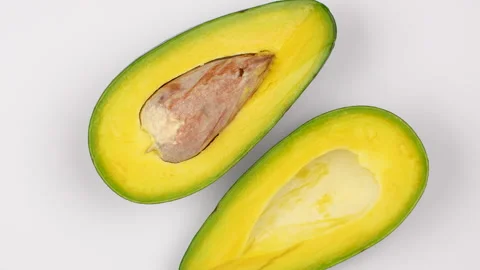 Macro Close Up Avocado Halves With Seed Rotating 4K Stock Footage 322085485