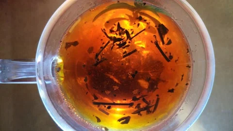 Macro close up of black tea brewing Stock Footage 138949944