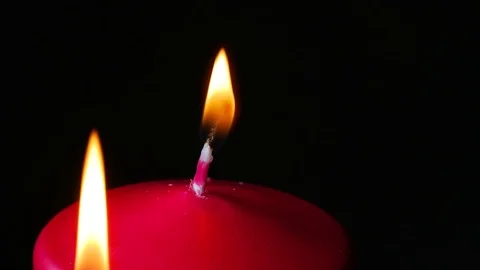 Macro close up blowing out candles makes smoke rotating around black background Stock Footage 70244685