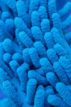 Macro close up of blue chenille microfiber texture for cleaning, trapping dus Stock Photos