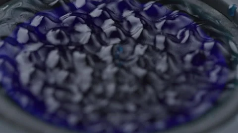 Macro Close up of Blue Liquid Vibrating with Stereo Sound Waves in Studio Light Stock Footage 208787211