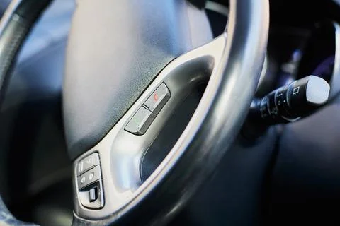 Macro close-up of bluetooth phone pick up button on wheel. Stock Photos