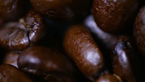Macro close up brown coffee beans rotating around 2 Video stock 70239818