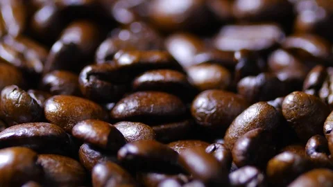 Macro close up brown coffee beans rotating around 4 Stock-Footage 70239843