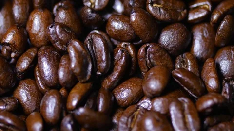 Macro close up brown coffee beans rotating around 3 Stock Footage 70239850