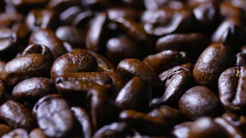 Macro close up brown coffee beans rotating around fast Stock Footage 70239987