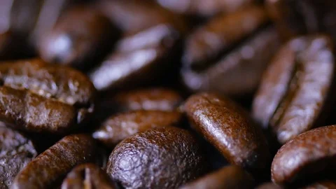Macro close up brown coffee beans rotating around Video stock 70241300